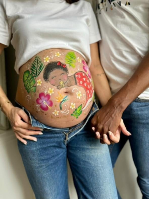 Femme enceinte arborant un magnifique belly painting coloré et artistique, parfait pour célébrer la grossesse.